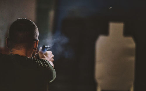 Rear view of man standing at night