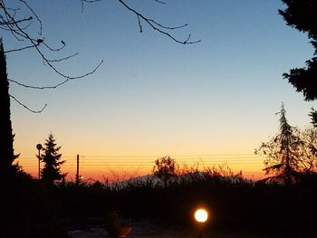 Silhouette trees against sky during sunset