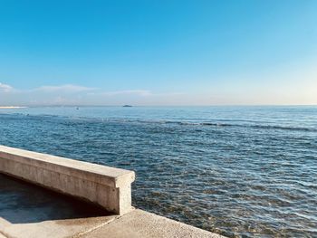 Scenic view of sea against clear blue sky