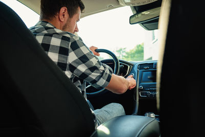 Rear view of man driving car