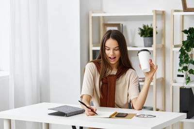 Portrait of young businesswoman working at office