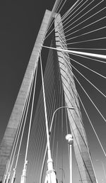 Low angle view of suspension bridge against sky