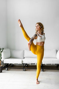 Beautiful woman performing yoga at home