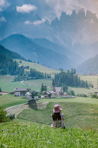 Woman on field with mountain range in background