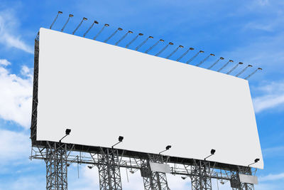 Low angle view of empty billboard against sky