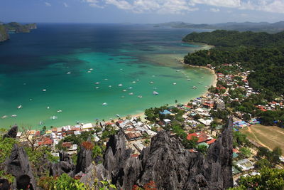 High angle view of buildings and sea against sky