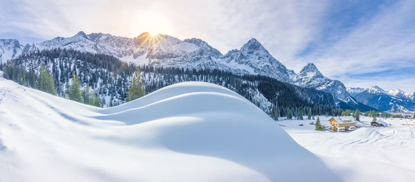 Snow covered landscape against the sky