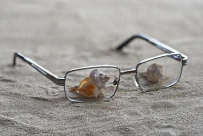 Close-up of sunglasses on glass table