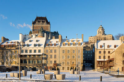 Buildings in city against clear sky