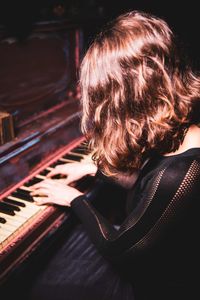 Woman playing piano at home