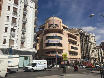 View of city street and buildings against sky