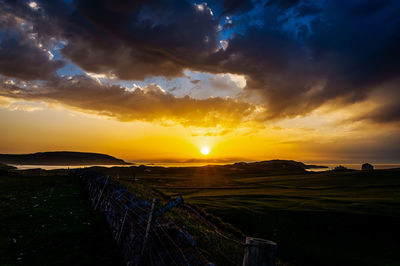 Scenic view of sunset over land