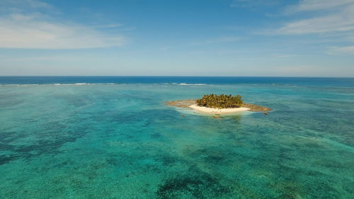 Aerial view of beautiful tropical island guyam with white sand beach. 