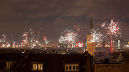 Firework display in sky at night