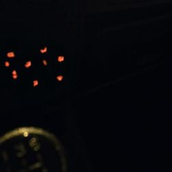 Close-up of illuminated lighting equipment against black background