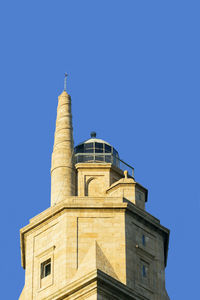 Tower of hercules against clear blue sky