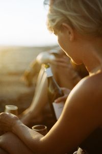 Friends enjoying drink during picnic