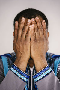 Close-up of man covering face