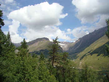 Scenic view of mountains against cloudy sky