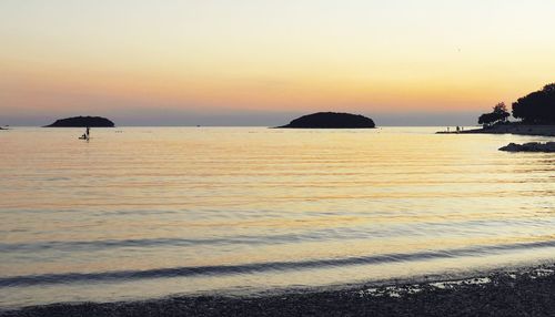 Scenic view of sea against clear sky during sunset