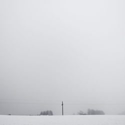 Snow covered field against sky