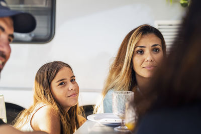 Mother and daughter sitting together