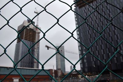 Close-up of chainlink fence against sky