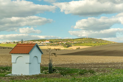 House on field against sky