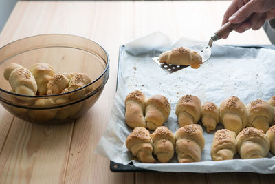 Close-up of hand holding baked food