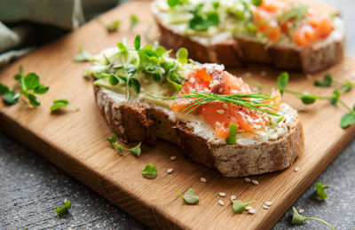 Sandwiches with salted salmon, avocado and microgreens. healthy food.