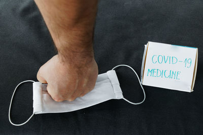 Midsection of man holding mobile phone