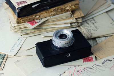 High angle view of camera and old books on table