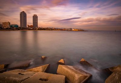 View of city at waterfront at sunset