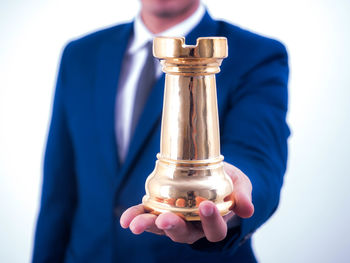 Close-up of man holding glass bottle