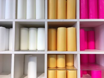 Full frame shot of candles rack at store