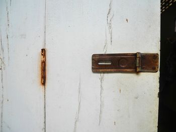 Close-up of old door knocker on wall