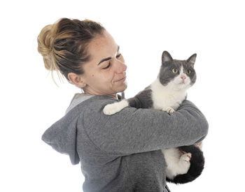 Portrait of cat against white background