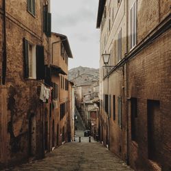 Narrow alley amidst historical residences in siena