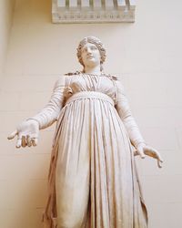 Low angle view of statue against wall