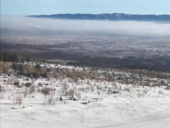 Aerial view of landscape against sky during winter