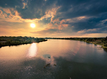 Scenic view of lake against sky during sunset