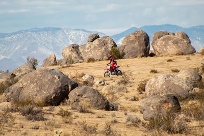 Man riding motorcycle on rock