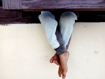 Low section of man standing on wall