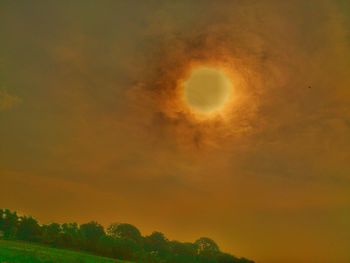 Low angle view of moon at sunset