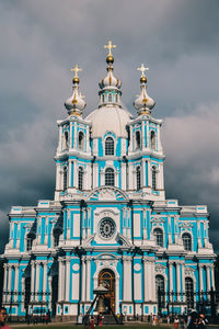 Low angle view of building against cloudy sky