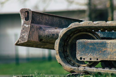 Close-up of old rusty machine on field