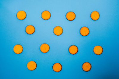 High angle view of multi colored candies against blue background