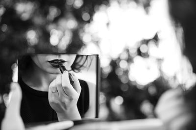 Midsection of woman holding umbrella