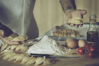 Midsection of person preparing food at table