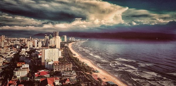 High angle view of sea and buildings against sky